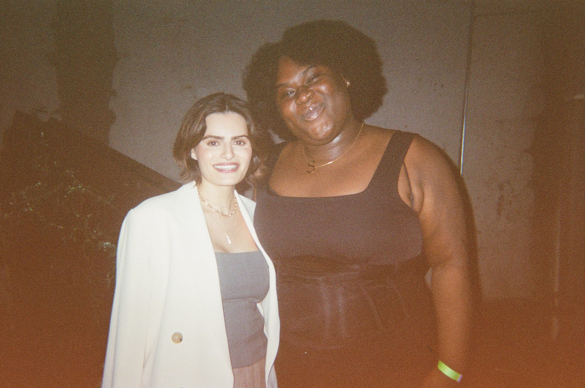 Sis thee doll posing with her friend Nava Mau. Sis is wearing a black tanktop and skirt while Nava is wearing a white blazer and grey halter top